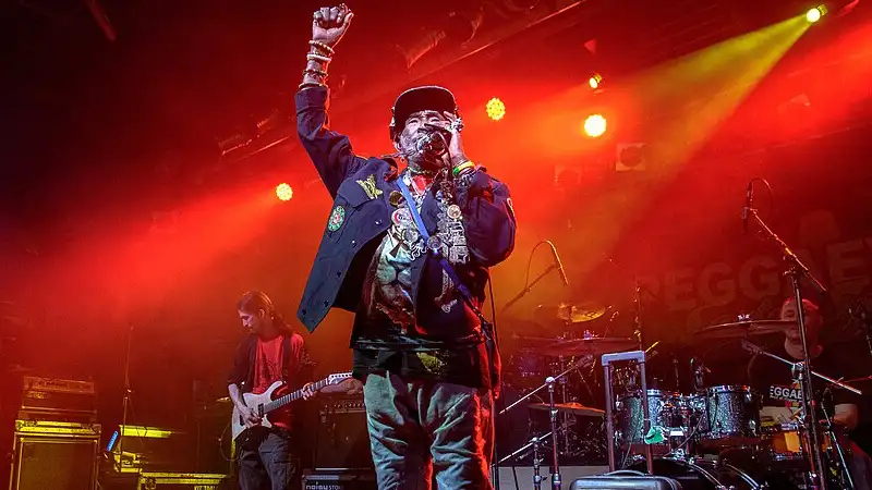 Image thanks to © pitpony.photography - www.pitpony.photography.de lee scratch perry performing live on stage with band at reggae concert.